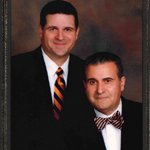 Formal portrait of a father and son lawyer partnership sharing a legacy